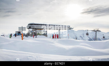 Moosfluh gondola station and Swiss ski instructors on top of ski slope in the snow in winter, Riederalp, Valais, Switzerland Stock Photo