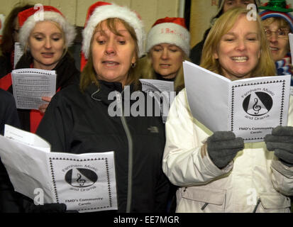 People carol singing on Farnham train station to fundraise for Marie Curie cancer charity, Farnham, Surrey, UK. Stock Photo