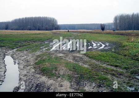 Rural roads near the river in autumn mud. Stock Photo