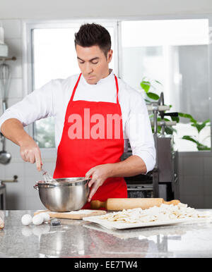 Chef Preparing Ravioli Pasta In Commercial Kitchen Stock Photo