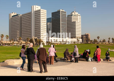 Israeli-Arab women in a family day out, sitting along the promenade in Tel Aviv, Israel Stock Photo
