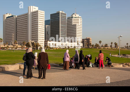 Israeli-Arab women in a family day out, sitting along the promenade in Tel Aviv, Israel Stock Photo