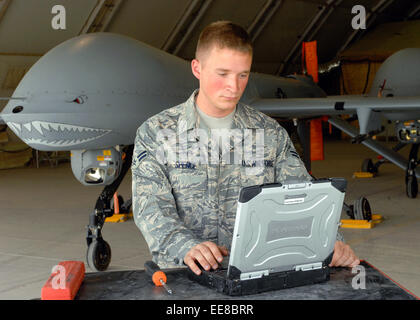 Airman 1st Class Troy Spence, 62nd Expeditionary Reconnaissance Squadron performs maintenance on a MQ-1 Predator UAV at Bagram Air Base, Afghanistan in support of Operation Enduring Freedom. See description for more information. Stock Photo
