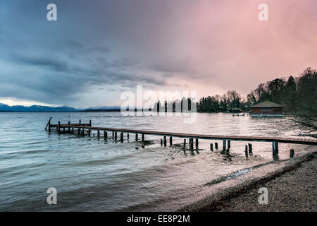 Evening mood of lake at Tutzing Bavaria Germany with clouds and landing stage Stock Photo