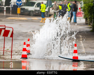 road spurt water beside traffic cones Stock Photo