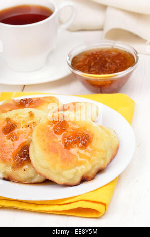 Fritters with yellow raspberry confiture on white wooden table Stock Photo