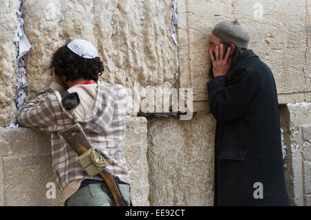 Jews devoutly pray at the Wailing Wall in Jerusalem, Judaism's holy site before Sabbath. Stock Photo