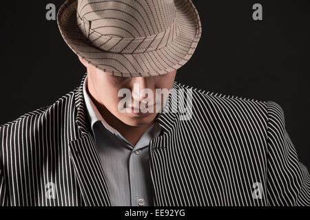 The man in style Chicago gangster on dark background Stock Photo