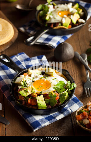 Homemade Heuvos Rancheros with Avocado and Cilantro Stock Photo