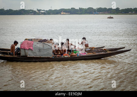 Men travelling by boat, flowing on Hooghly river in Kolkata, West Bengal, India. Stock Photo
