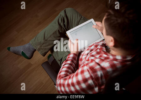 Adult man on tablet pc Stock Photo