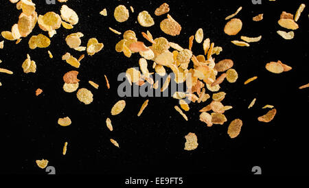 Flying corn flakes isolated on black background Stock Photo