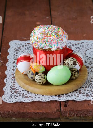 Easter cake with glace icing and colored easter eggs rustic style Stock Photo