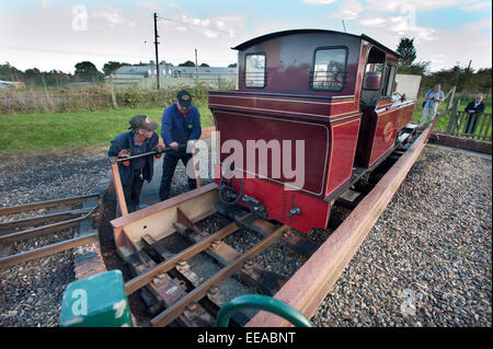 The driver and fireman use the Turntable at Wroxham station terminus to turn their 15-Inch narrow gauge steam locomotive 'Mark Timothy' before it runs round its train on The Bure Valley Railway to return to Aylsham on the 9 miles between Aylsham and Wroxham, near Norwich, Norfolk. Stock Photo