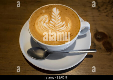 A Perfect Flat White Coffee with Silver Fern Barista Design Served in a Tulip Style Cup Stock Photo