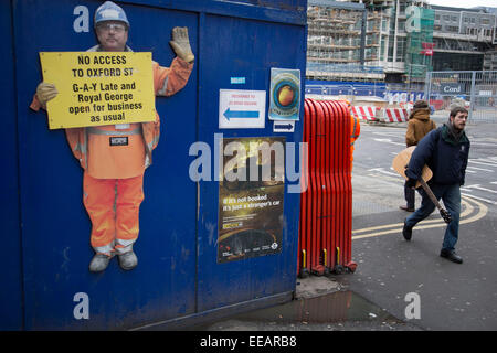 Cutout workman at the Crossrail development site at Tottenham Court Road, holding up a sign saying that businesses are open for business as usual. Including the nightclub GAY. London, UK. Stock Photo