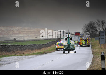 Air Ambulance attending a road traffic accidentin icy weather, Kirkby Stephen, Cumbria, UK Stock Photo