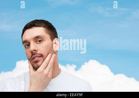 beautiful calm man touching his face Stock Photo