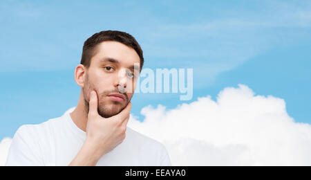 beautiful calm man touching his face Stock Photo