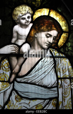 Stained Glass Window Of A Child With A Figure Representing Charity by Designer: Henry Holiday & Firm: James Powell & Sons 1880 Stock Photo