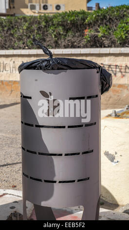 Waste bin with Apple motif on the side Stock Photo