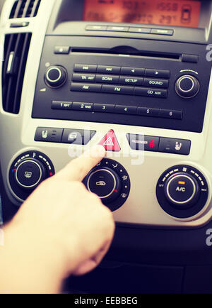 man pressing car hazard warning button Stock Photo