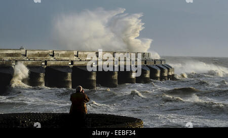 Brighton, UK. 15th January, 2015. UK Weather: A photographer tries to capture the huge waves crashing over Brighton Marina Stock Photo