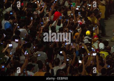 Manila, Phillipines. 15th January, 2015. People raise their mobile devices as Pope Francis arrives in Baclaran on Thursday, January 15, 2015. The Pope is visiting the Philippines from January 15 to 19. Credit:  Mark Fredesjed Cristino/Alamy Live News Stock Photo