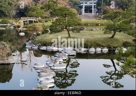 Kumamoto, Kyushu, Japan. The stroll garden of Suizen-ji Joju-en, begun in 1632. The pond with the Izumi Shrine in the background Stock Photo