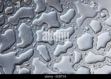 Water effect on the top of a stainless steel table. Stock Photo
