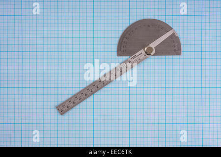 Protractor on graph paper background Stock Photo