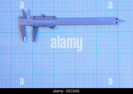 Vernier-caliper on graph paper under blue light Stock Photo