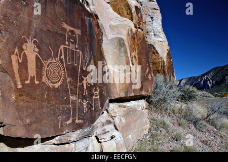 A large panel of ancient petroglyphs on a rock face at McKee Springs off the Rainbow Park Road in Dinosaur National Monument Maybell, Utah. Stock Photo