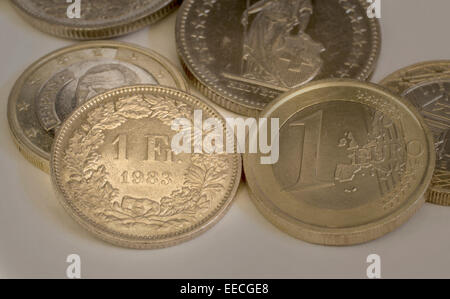 Swiss francs and Euro coins Stock Photo