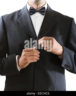 hands of the man who in a black tuxedo clasps a jacket button Stock Photo