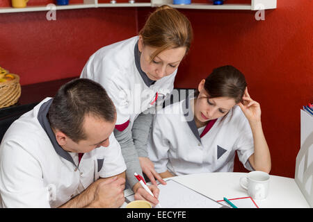 nurse instructs other employees in the break room Stock Photo