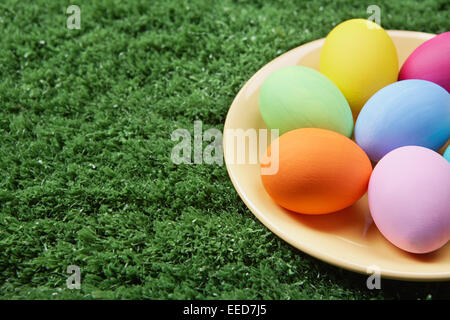 Close-up of coloured Easter eggs on plate Stock Photo