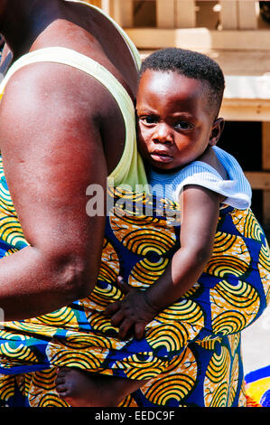 African baby carried on the back of his mother. Togo Stock Photo - Alamy