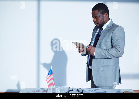 Young businessman with digital tablet networking in office Stock Photo