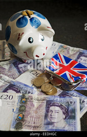 Close up of Piggy bank and English money banknotes banknote cash coins finance business concept England UK United Kingdom GB Great Britain Stock Photo