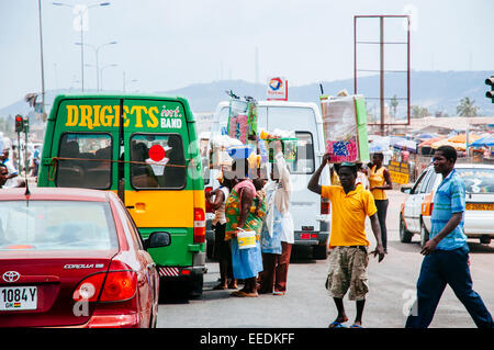 Street vendors take advantage of traffic jam to sell producs on the road, Accra, Ghana. Stock Photo