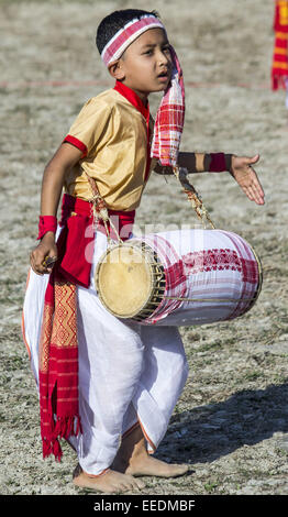 Sivasagar, Assam, India. 16th Jan, 2015. An Indian little boy play a 'Dhol' - traditional Assamese drum during Bhogali Bihu celebrations in Sivasagar district of northeastern Assam state on January 16, 2015. The festival marks the end of the winter harvesting and is celebrated on the first day of 'Magh' month of Assamese calendar. Credit:  Luit Chaliha/ZUMA Wire/ZUMAPRESS.com/Alamy Live News Stock Photo