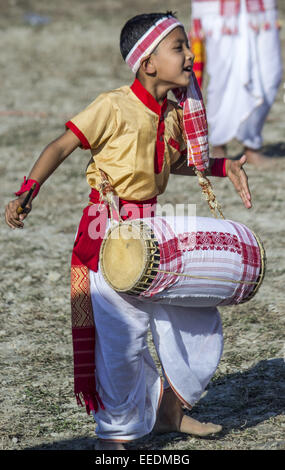 Sivasagar, Assam, India. 16th Jan, 2015. An Indian little boy play a 'Dhol' - traditional Assamese drum during Bhogali Bihu celebrations in Sivasagar district of northeastern Assam state on January 16, 2015. The festival marks the end of the winter harvesting and is celebrated on the first day of 'Magh' month of Assamese calendar. Credit:  Luit Chaliha/ZUMA Wire/ZUMAPRESS.com/Alamy Live News Stock Photo