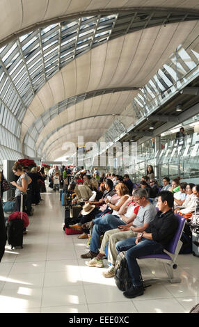Travellers waiting to board airplane at gate, Suvarnabhumi Airport, Bangkok, Thailand, Southeast Asia. Stock Photo