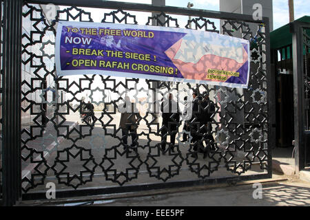 Jan. 16, 2015 - Rafah, Gaza Strip, Palestinian Territory - Members of security forces stand guard at the entrance of Rafah border crossing between Egypt and southern Gaza Strip as Palestinians perform Friday prayers on January 16, 2015, to demand that Egyptian authorities open the crossing. Egypt shut Rafah crossing, Gaza's main window to the outside world, over violence with Islamist militants in Egypt's adjacent Sinai region last October. Since then, it opened the crossing for a few days to allow thousands of Palestinians get in and out of Gaza Strip  (Credit Image: © Abed Rahim Khatib/APA I Stock Photo