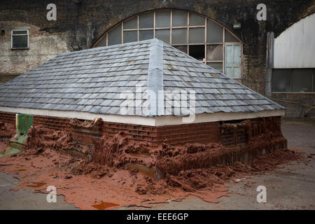 A Pound of Flesh for 50p, also known as Melting House, is a temporary outdoor sculpture by artist Alex Chinneck, located in London, UK. Part of the city's Merge Festival, the two-story house sculpture was constructed from 8,000 paraffin wax bricks and is designed to melt with assistance from a heating apparatus. Stock Photo