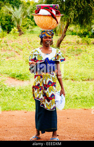 Portrait of Fulani woman carrying a big pumpkin on head, Mali. Stock Photo
