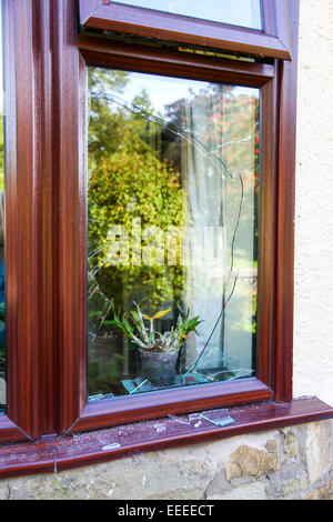 A broken double glazed window after an attempted break in or burglary Stock Photo