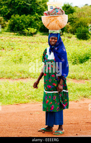 Portrait of Fulani woman carrying a big pumpkin on head, Mali. Stock Photo