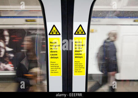 Items trapped in doors warning on 2009 stock Victoria line train Stock Photo